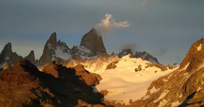 Golden light on rugged snow-covered mountain peaks