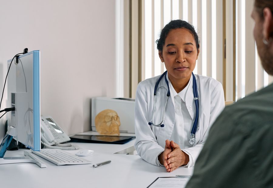 A doctor consulting a patient in a bright medical office
